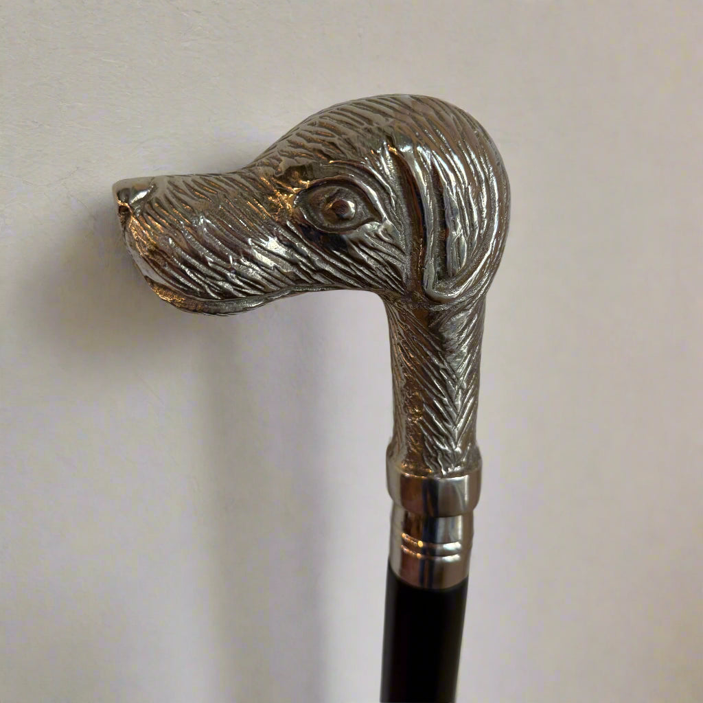 White metal mounted walking cane with a handle formed as the head of a dog