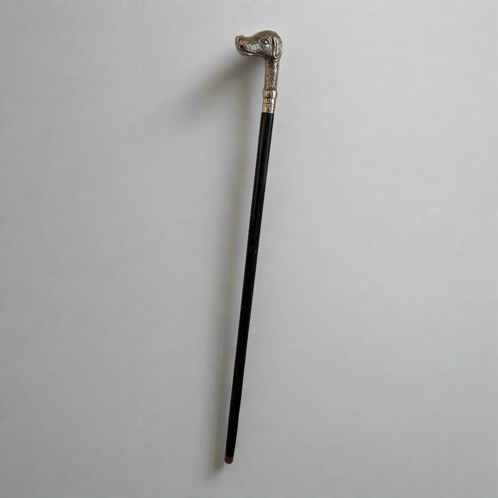 White metal mounted walking cane with a handle formed as the head of a dog