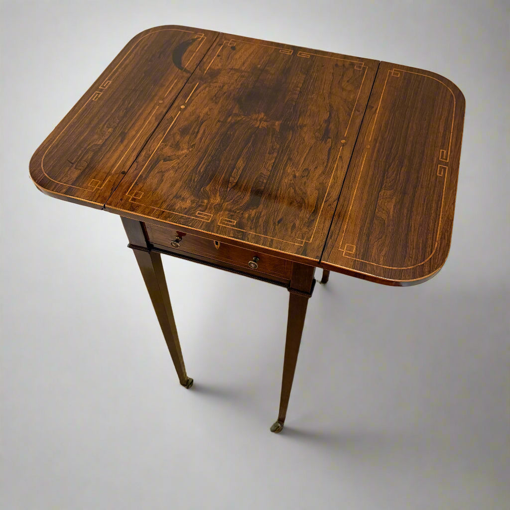 Regency rosewood work table on square tapering legs and castors 