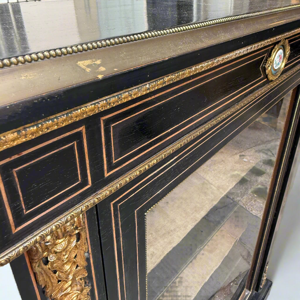 Victorian ebonised and gilt metal mounted pier cabinet with porcelain floral plaque 