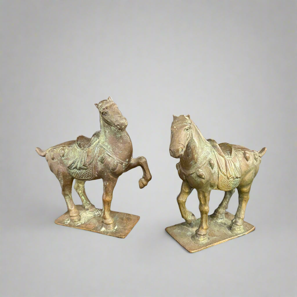 Pair of early 20th century Chinese patinated bronze Tang style horses with archaic script to the base