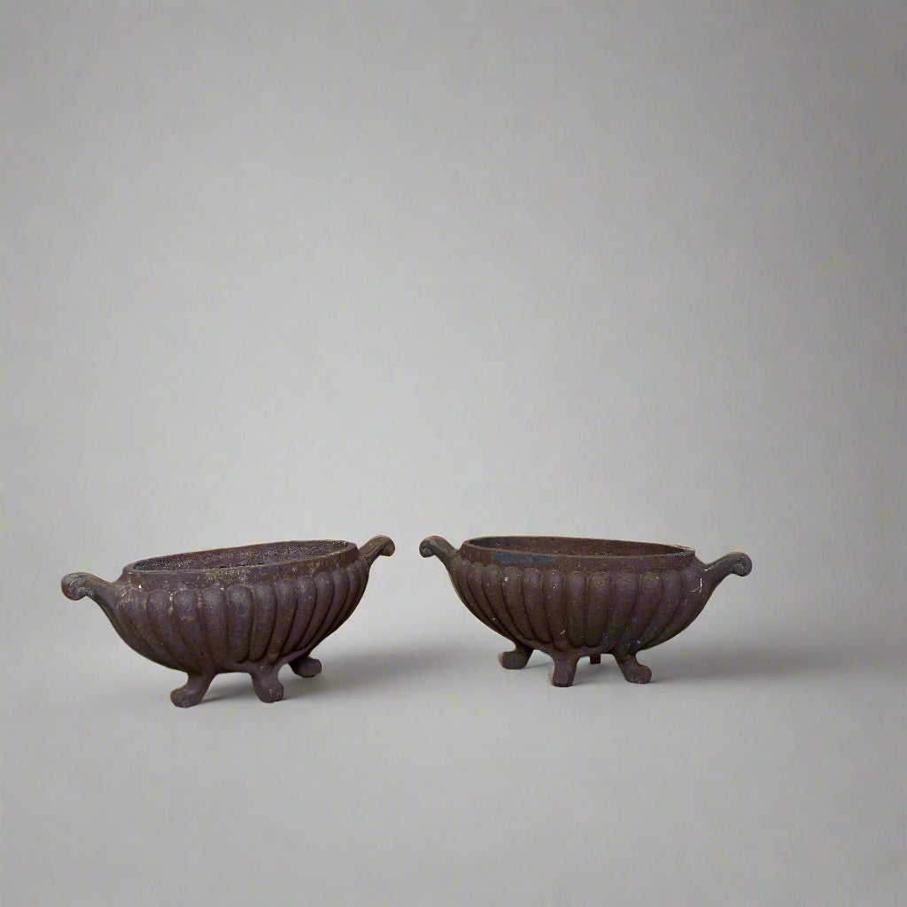 Pair of heavy Victorian fluted cast iron urns