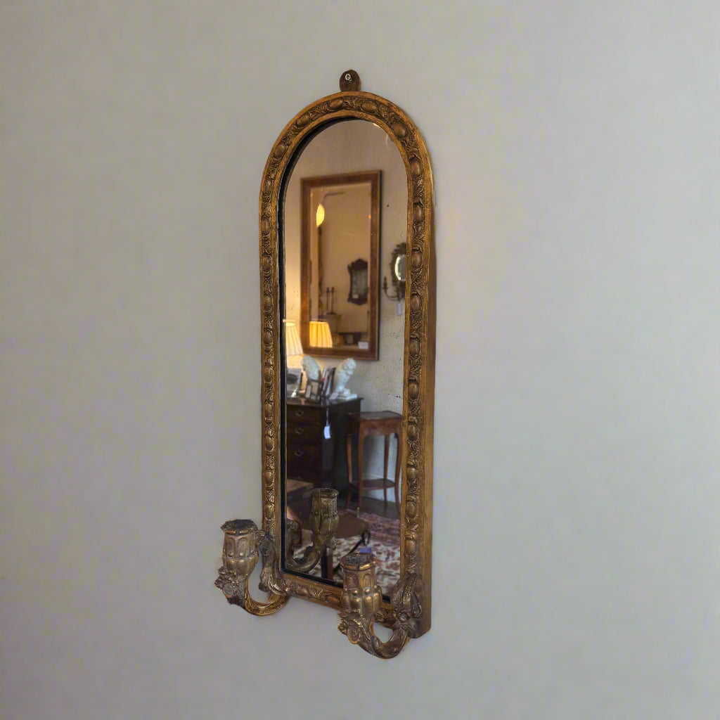Pair of late 19th century gilt wall mirrors with carved candle holders and carved frame arched top 