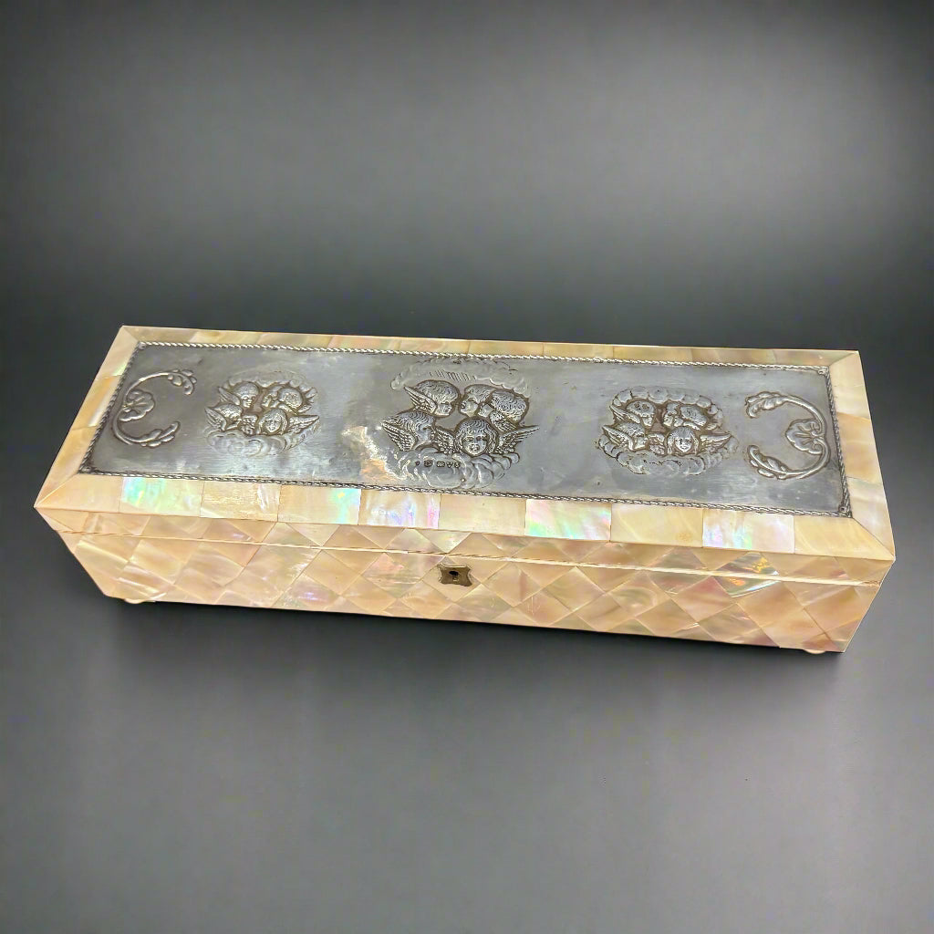 Mother of pearl velvet lined box with silver top embossed with Reynolds angels made in Chester 1903