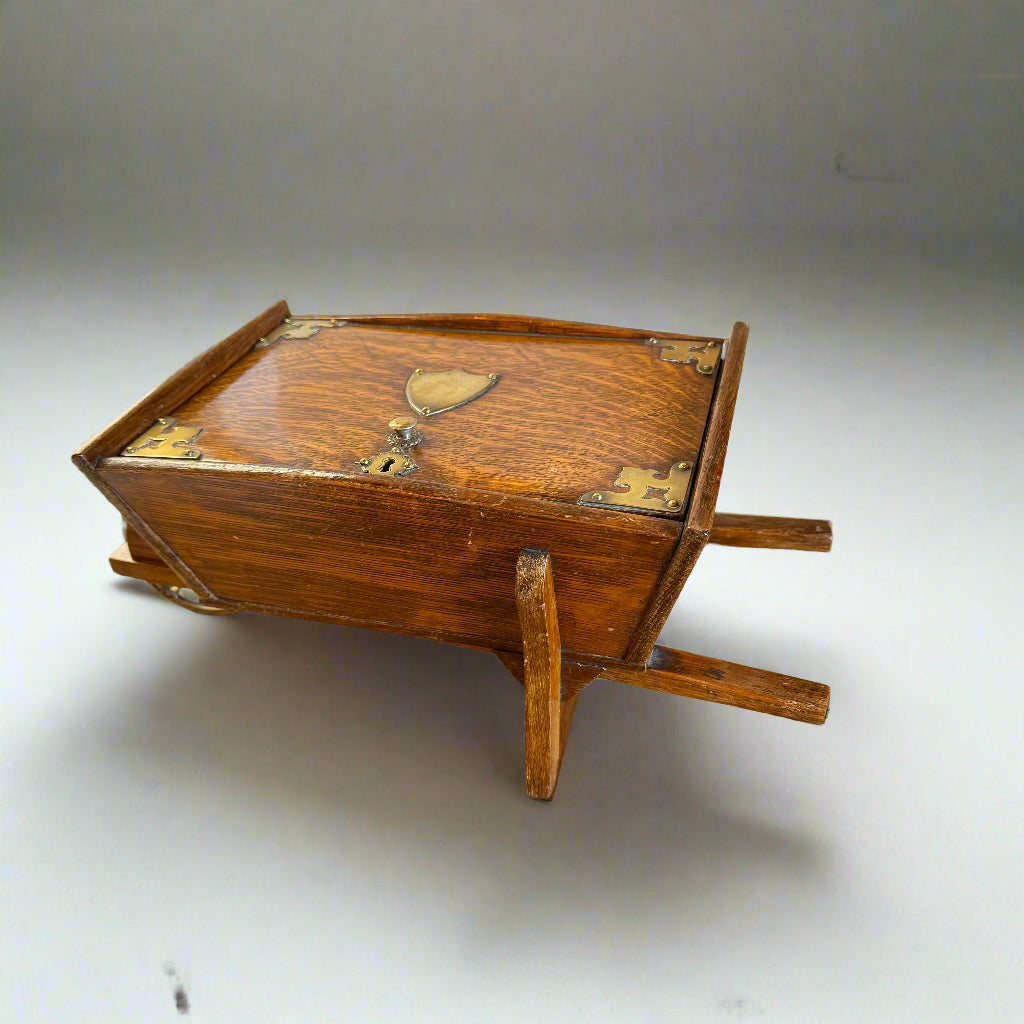 19th century oak brass-bound humidor in the shape of a wheelbarrow 
